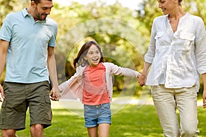 Happy family walking in summer park