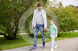 Happy family walking in summer park