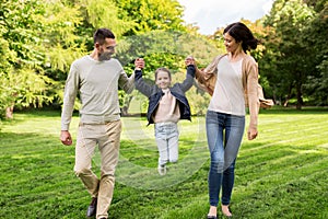 Happy family walking in summer park and having fun