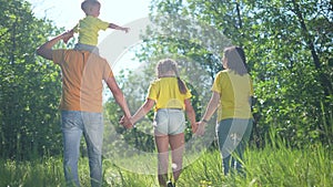 happy family walking together in the park silhouette. friendly family kid dream concept. happy family walking holding