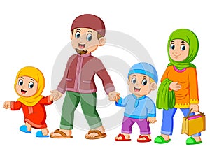 A happy family are walking together with their new clothes for celebrating ied mubarak