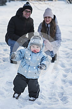 Happy family walking in winter park