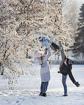 Happy family walking in winter park