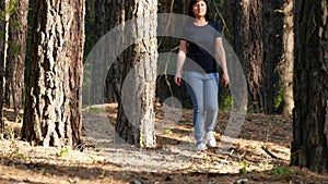 Happy family walking in the woods enjoying nature. Cute little boy running through the forest.