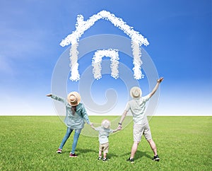 Happy  family watching the sky with home and house symbol concept