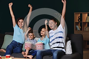 Happy family watching TV in evening