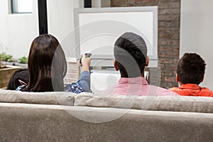 Happy family watching tv on the sofa