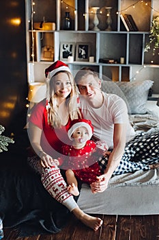 Happy family wearing pajamas spending time together in Christmas morning.