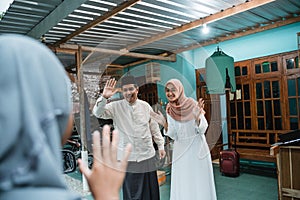 happy family welcoming guest to their house during eid mubarak