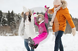 Happy family in winter clothes walking outdoors