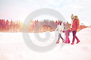 Happy family in winter clothes walking outdoors