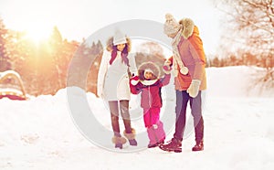 Happy family in winter clothes walking outdoors