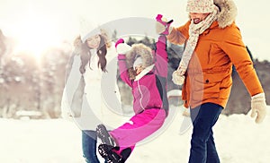 Happy family in winter clothes walking outdoors