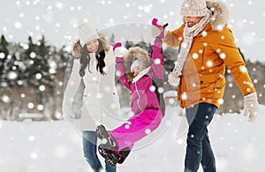 Happy family in winter clothes walking outdoors