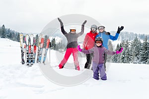 Happy family in winter clothing at ski resort - skiing, winter, snow, fun - mom and daughters enjoying winter vacations