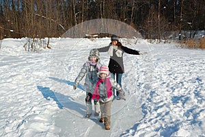 Happy family in winter, having fun and playing with snow outdoors on holiday weekend