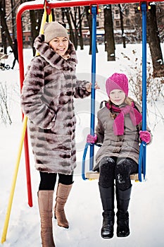 Happy Family in Winter. Mother and Daughter