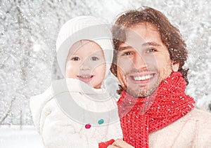 Happy family on a winter walk, father and child baby daughter outdoors