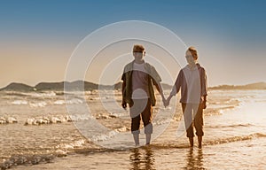 Happy family woman and man gray hair elderly older retire relax together while sunset seaside