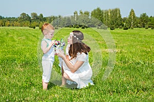 Happy family. Young mother and kid boy on sunny day. Portrait mom and son on nature. Positive human emotions, feelings, joy.