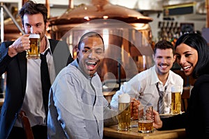 Happy fans watching TV in pub cheering