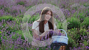 Happy farm girl with flowers basket, lavender field.