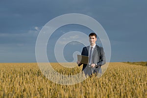 Happy farmer. buisnessmen in a wheat field