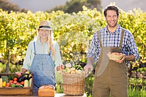 Happy farmer couple presenting their local food