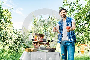 happy farmer showing ripe ecological vegetables