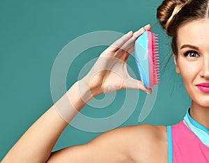 Happy fashion brunette woman close eye with colorful pink blue popular hair comb brush