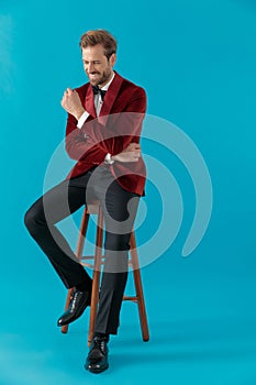 Happy fashion man wearing red velvet tuxedo and smiling