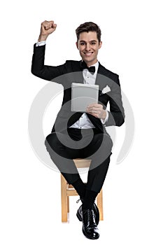 Happy fashion model holding tab and celebrating victory