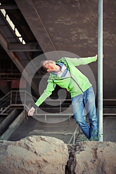 Happy fashion teen boy in sweatshirt walking outdoor