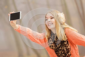 Happy fashion woman in park taking selfie photo.
