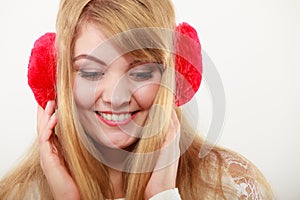 Happy fashionable girl in red earmuffs