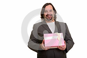 Happy fat Caucasian businessman smiling and holding gift box