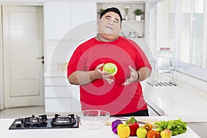 Happy fat man preparing to make a tasty salad