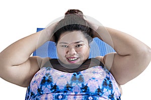 Happy fat woman doing abdominal sit ups