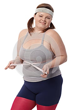 Happy fat woman with tape measure