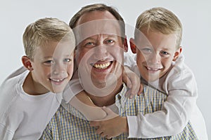 Happy father with 6 years old identical twins photo