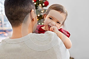 happy father and baby girl over christmas tree