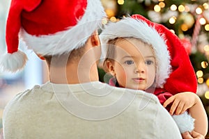 happy father and baby girl over christmas tree