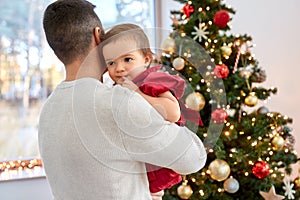 happy father and baby girl over christmas tree