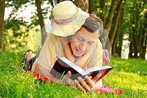 Happy father with a child reading a book on the nature of the Bible