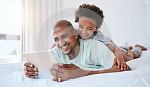 Happy father, child and watching on tablet in bed for fun streaming or entertainment together at home. Dad, son or kid