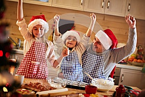 Happy father and children making Christmas cookies