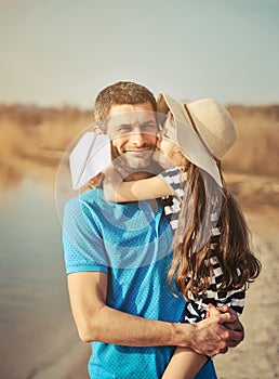 Happy father and daughter on the beach. Father`s day concept.