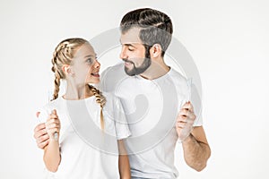 Father and daughter with toothbrushes