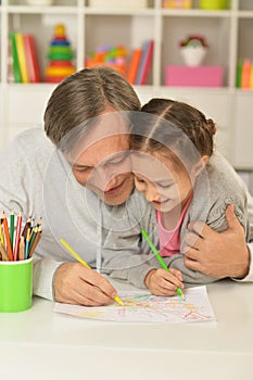 Happy father and daughter painting