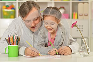 Happy father and daughter painting